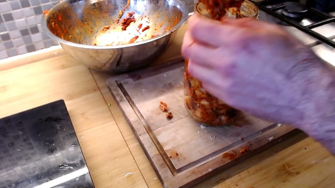 Kimchi in een pot aandrukken